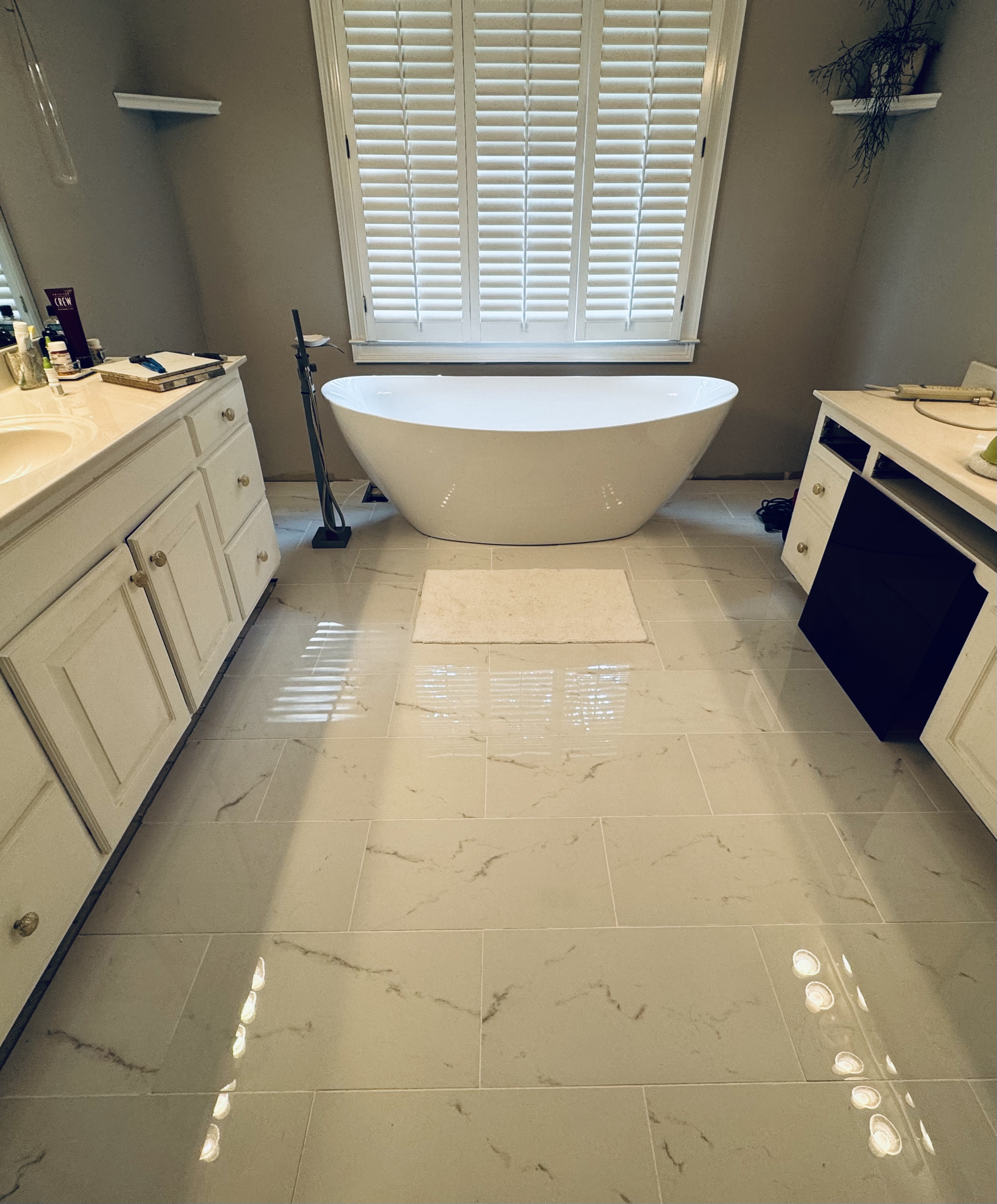 Akribeia primary bathroom renovation with freestanding tub and dual vanities